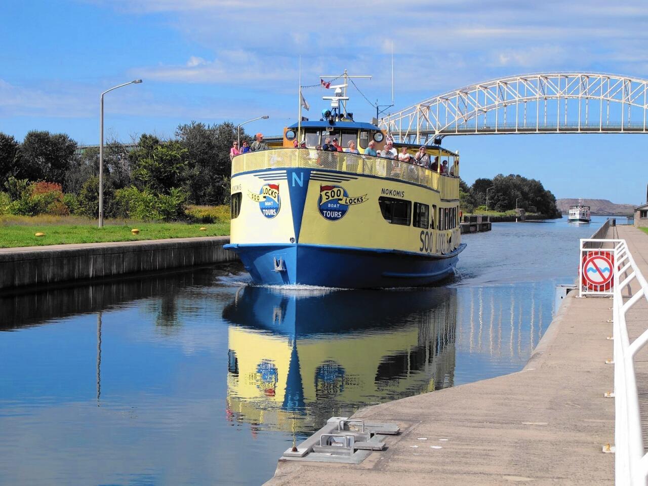 A Soo Locks Boat Tours vessel takes passengers through locks on the St. Marys River.