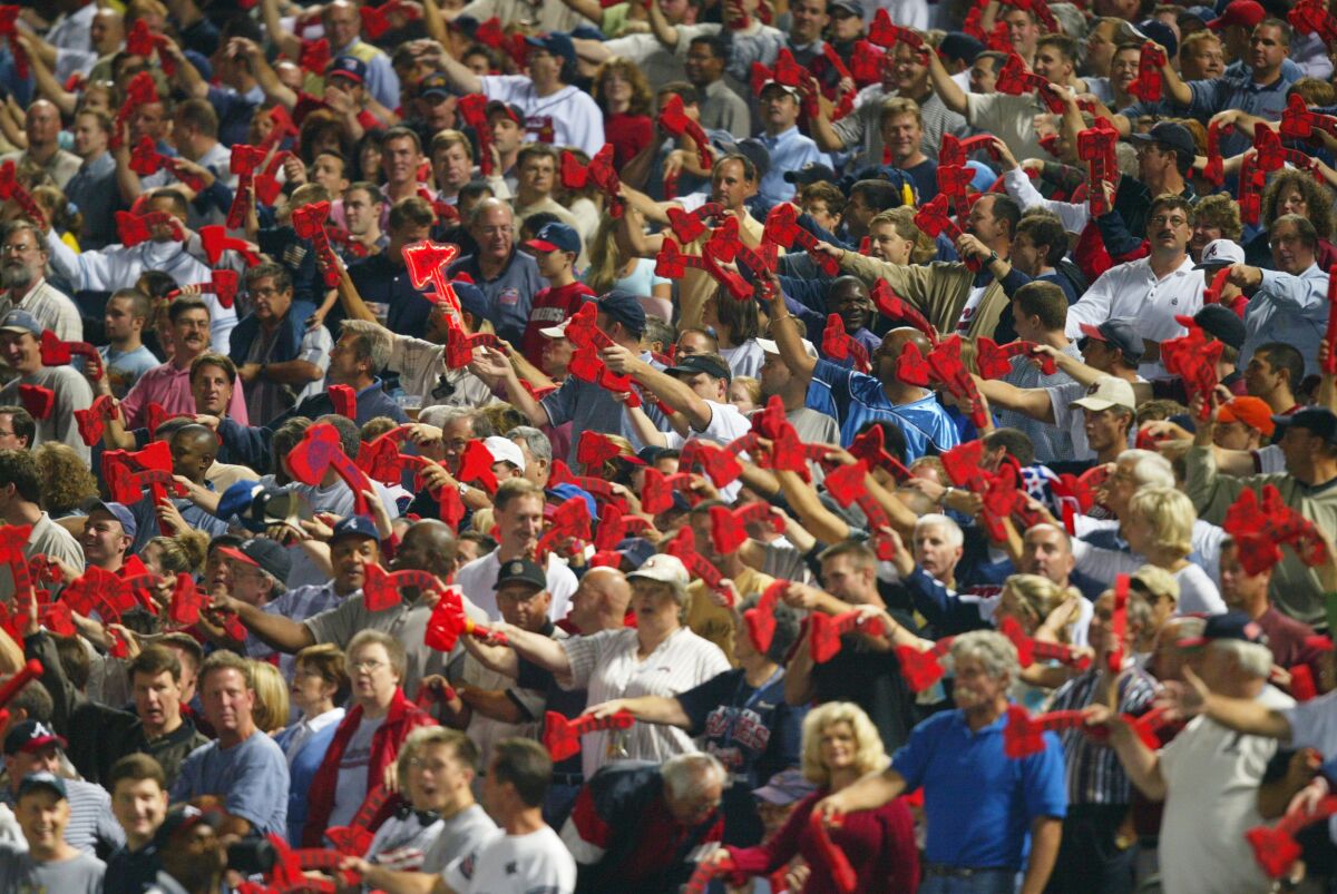 Fans of the Atlanta Braves do the tomahawk chop during a game against the San Francisco Giants.