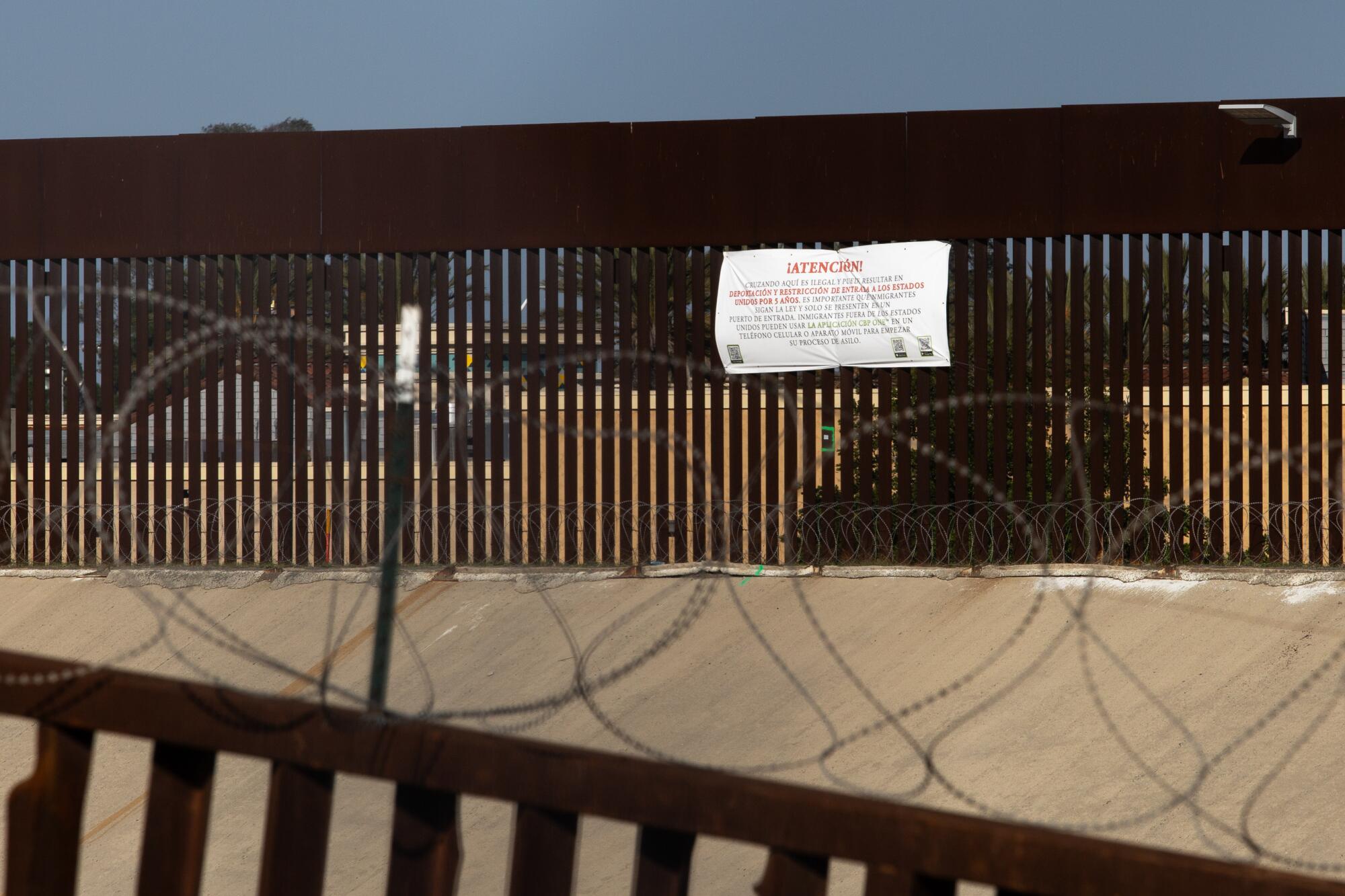 Un letrero para disuadir a migrantes fue colocado en la canalización del Río Tijuana