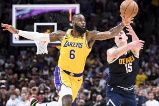 DENVER, CO - MAY 18: Los Angeles Lakers forward LeBron James, left, steals a pass intended for Denver Nuggets center Nikola Jokic during the second half of game two in the NBA Playoffs Western Conference Finals at Ball Arena on Thursday, May 18, 2023 in Denver, CO. (Wally Skalij / Los Angeles Times)