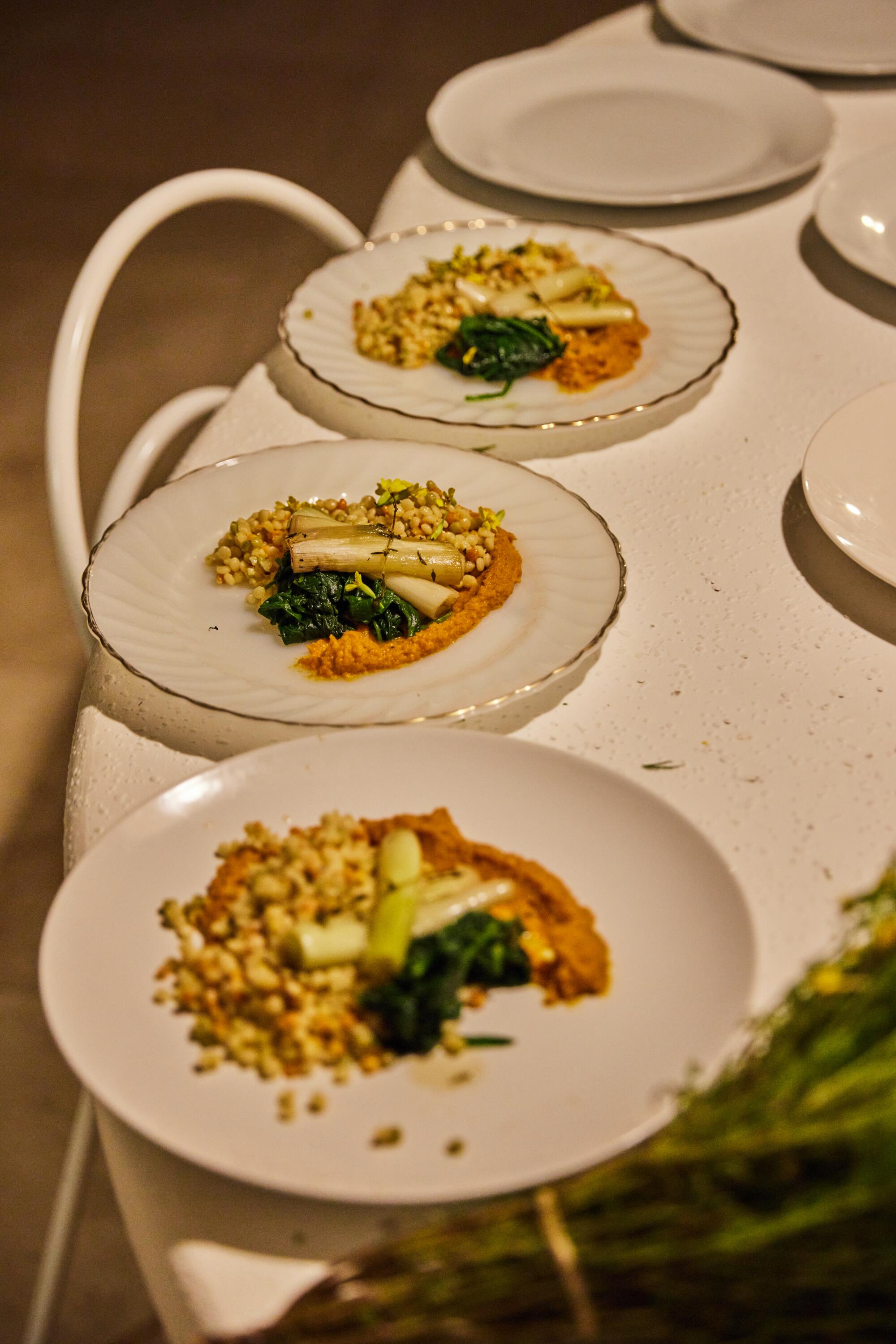 The main course: lemon and thyme couscous, carrot puree, sauteed spinach and braised leeks.
