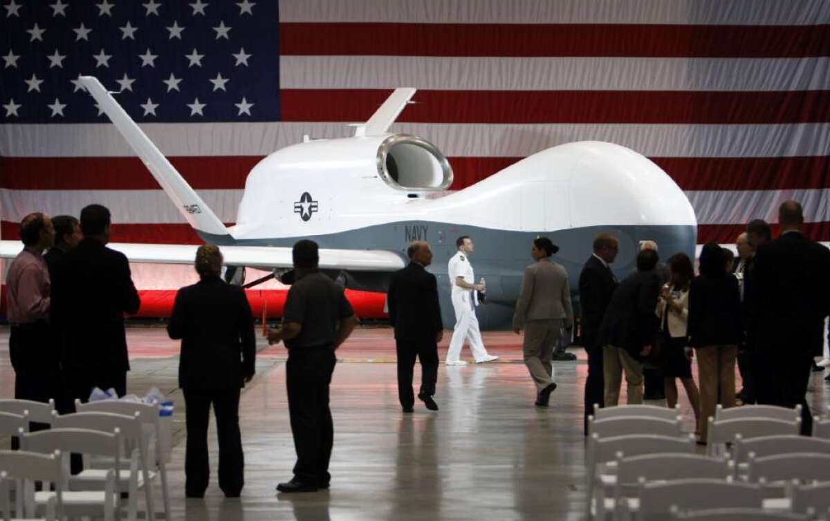 Officials view the naval version of Northrop Grumman Corp.'s Global Hawk spy drone at the company's Palmdale manufacturing facility.