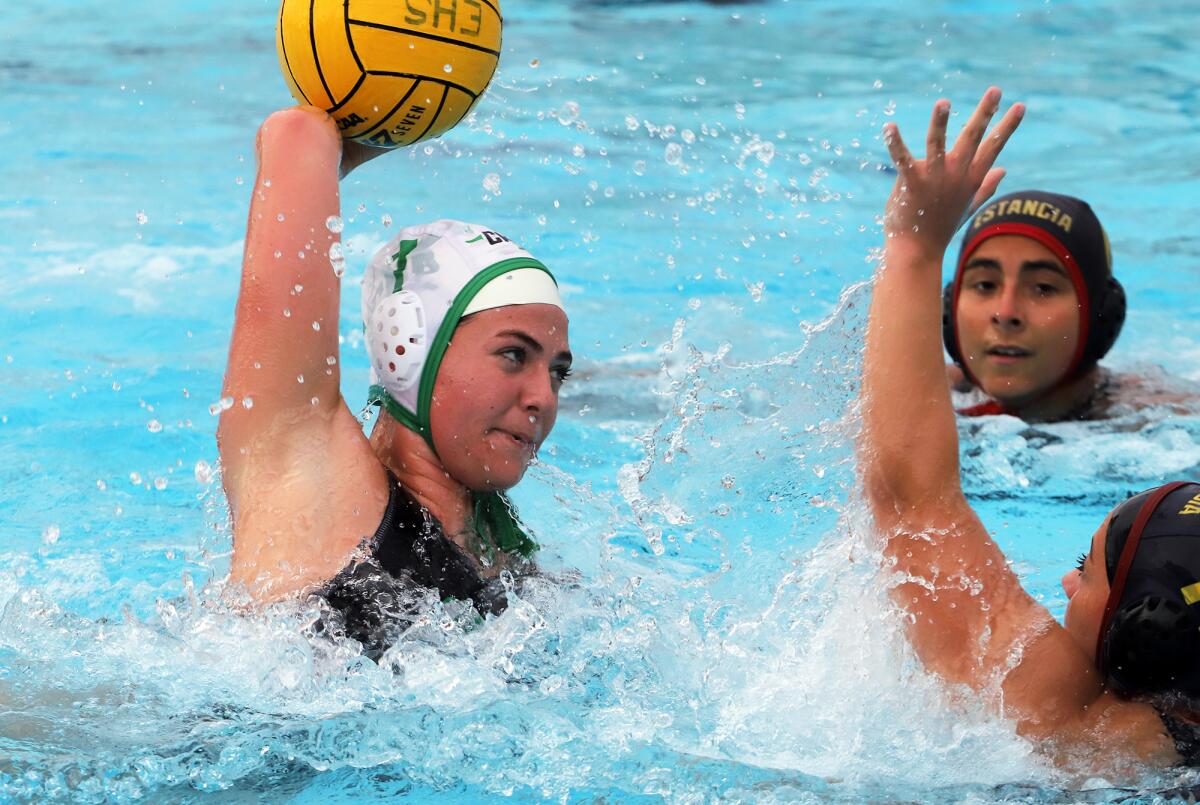 Costa Mesa's Kennedy Walker (7) tries to score over Estancia defenders on Wednesday.