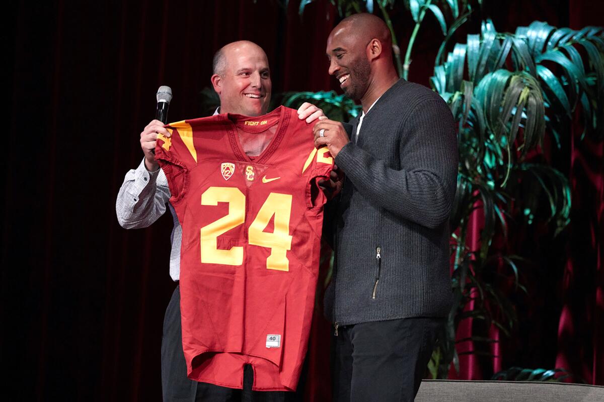 Kobe Bryant is presented with an honorary USC jersey at an April 2018 campus forum.