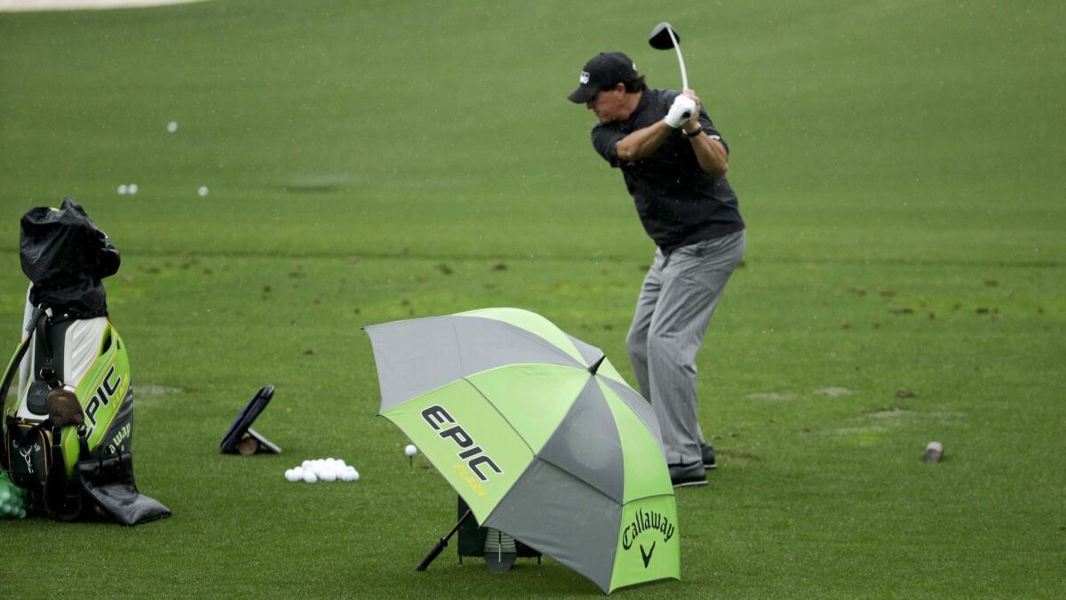 Phil Mickelson hits at the driving range during practice for the Masters golf tournament on Tuesday in Augusta, Ga.