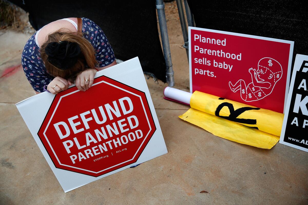 An antiabortion protester demonstrates in front of a proposed Planned Parenthood location in Washington on Sept. 21.