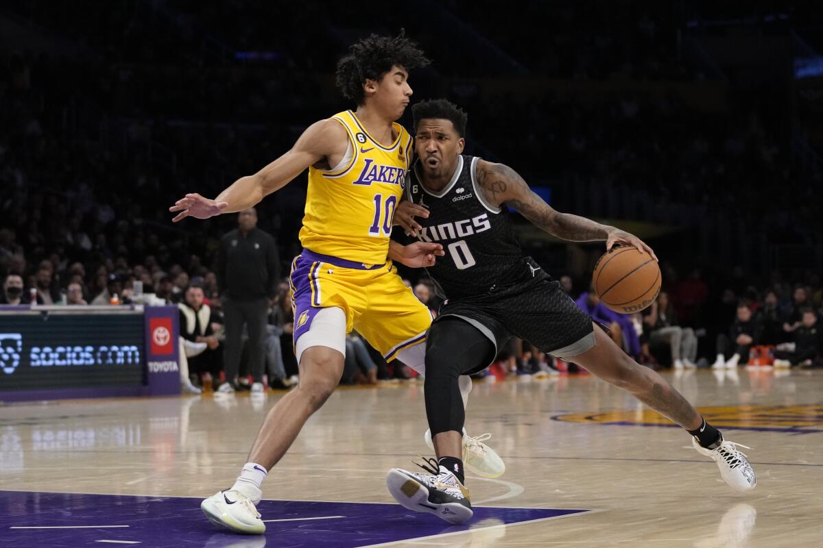 Los Angeles Lakers guard Max Christie defends against Sacramento Kings guard Malik Monk.