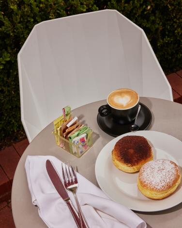 An outdoor table with pastries and coffee from edo bites in Pacific Palisades.