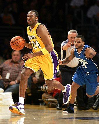 Kobe Bryant brings the ball down court with Orlando's Jameer Nelson on his heels.