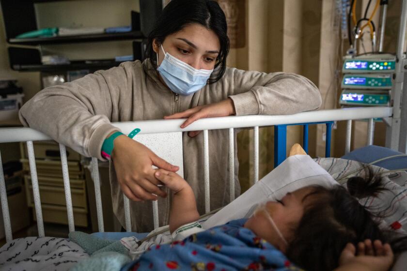 Loma Linda, CA - December 28: Priscilla Velazco keeps a watchful eye on her 6-month-old daughter Emilia Zarazua, at Loma Linda University Children's Hospital on Wednesday, Dec. 28, 2022, in Loma Linda, CA. Her daughter Emilia had fallen ill with the respiratory syncytial virus, or RSV, just one of the viruses that had been filling the beds at the pediatric intensive care unit for weeks. (Editors note: NO RESALES) (Francine Orr / Los Angeles Times)