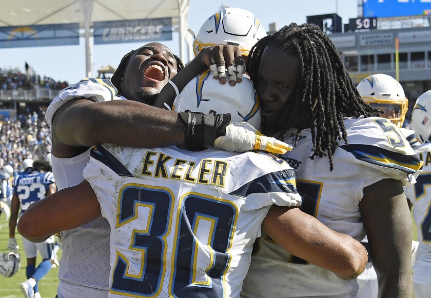 Chargers running back Austin Ekeler celebrates with teammates.