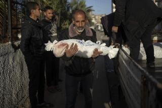 A Palestinian man carries the body of his grandson who was killed in the Israeli bombardment of the Gaza Strip, at the hospital Rafah, southern Gaza, Friday, Dec. 22, 2023. (AP Photo/Fatima Shbair)
