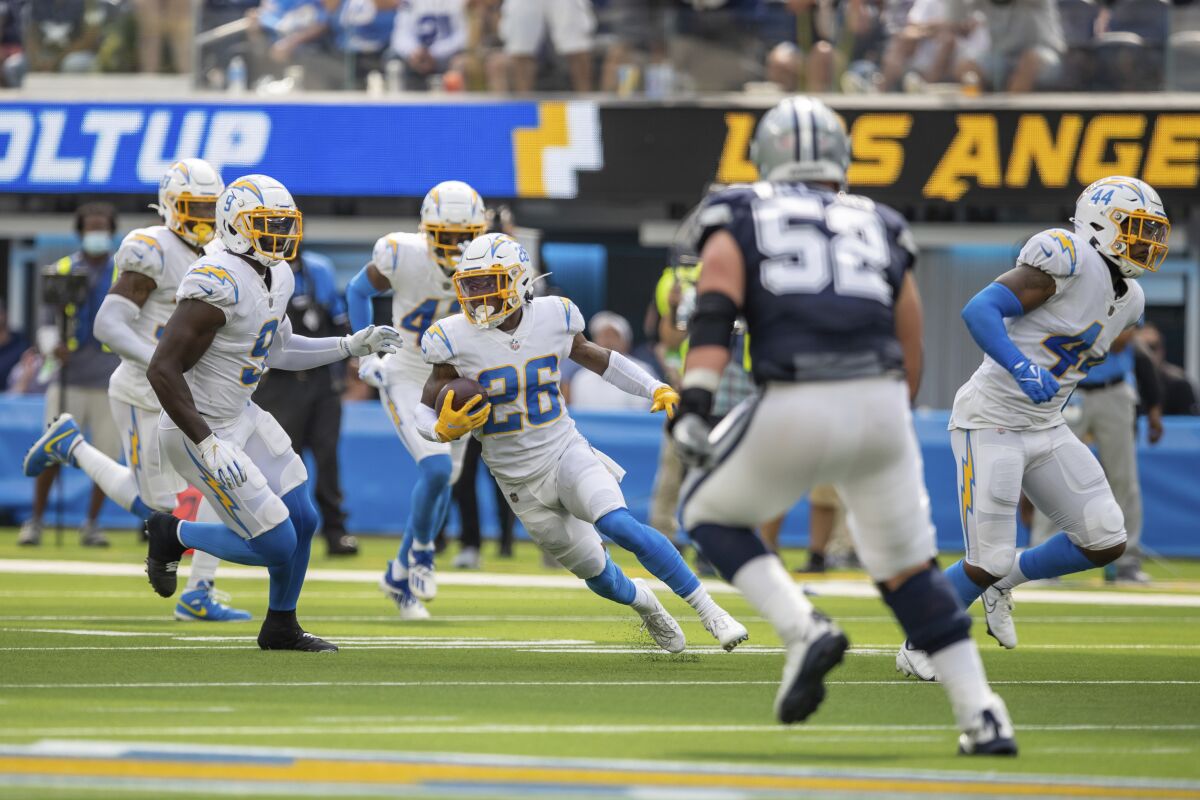 Chargers cornerback Asante Samuel Jr. runs after intercepting a pass against the Cowboys.