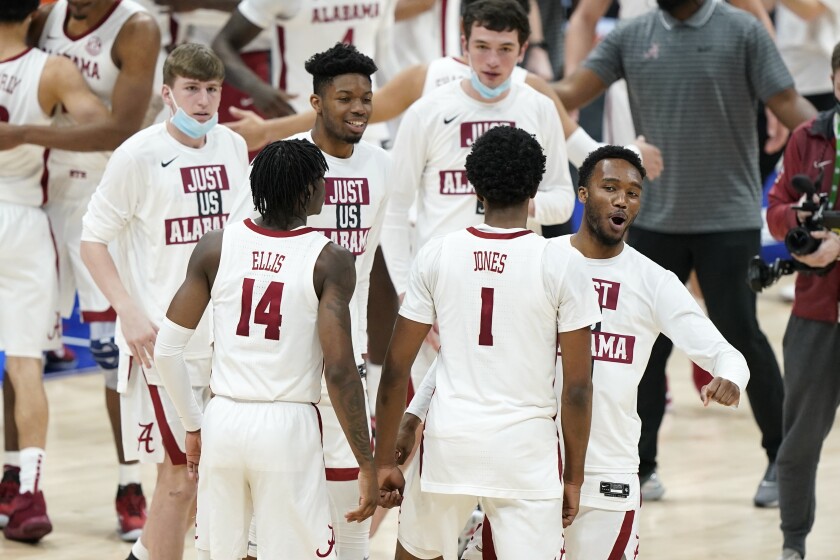 Alabama's Keon Ellis (14) and Herbert Jones (1) leave the court after Alabama beat Tennessee in an NCAA college basketball game in the Southeastern Conference Tournament Saturday, March 13, 2021, in Nashville, Tenn. (AP Photo/Mark Humphrey)