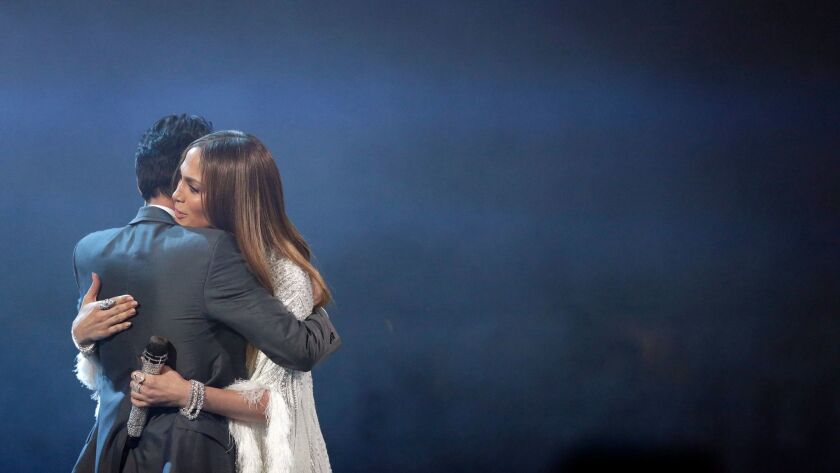 Marc Anthony embraces Jennifer Lopez after they perform during the 17th Latin Grammy Awards in Las Vegas.