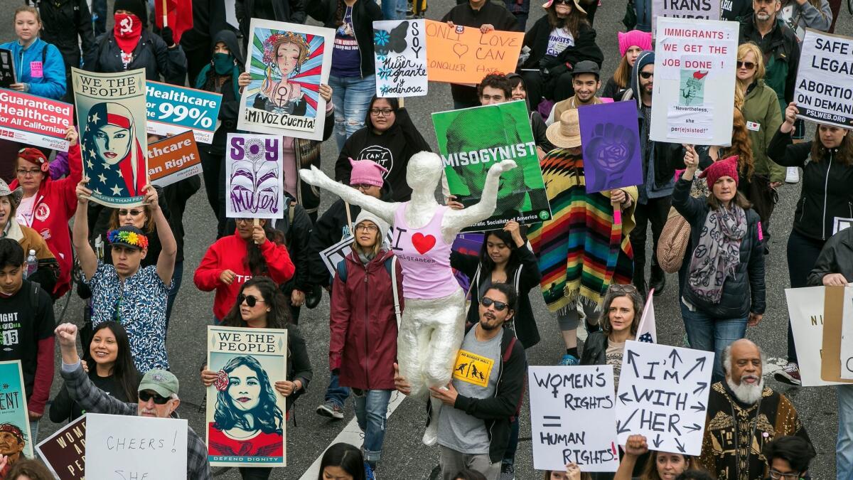 People participate in a march through downtown Los Angeles honoring International Women's Day on March 5.