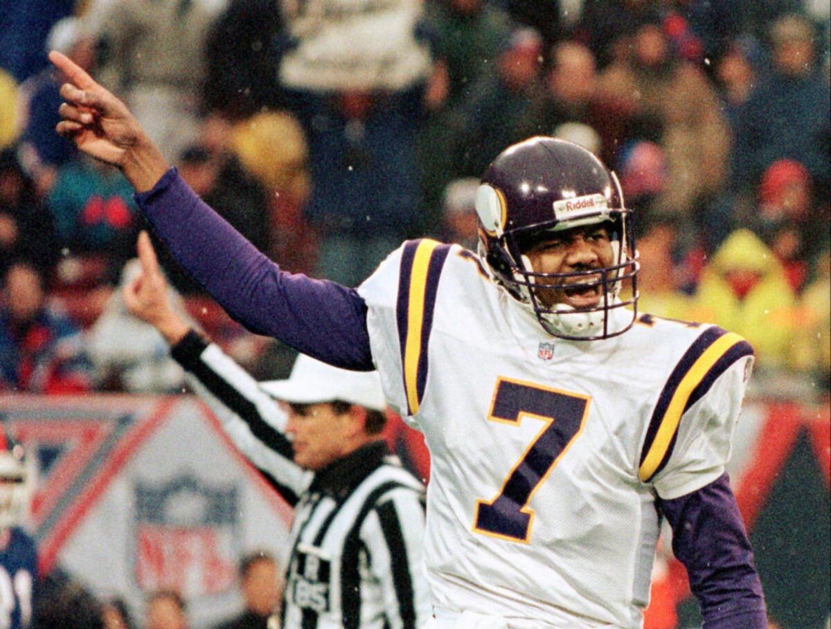 Then-Vikings quarterback Randall Cunningham gestures during a game on Dec. 27, 1997.