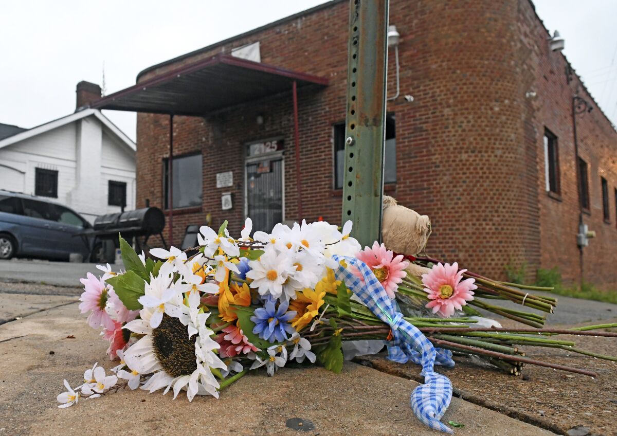 A makeshift memorial sits at the base of a street sign outside Mary's Bar and Grill, Tuesday, June 7, 2022, in Chattanooga, Tenn. A shooting near the Tennessee nightclub early Sunday, June 5, led to three deaths and 14 people suffering gunshot wounds and other injuries, police said. (Robin Rudd/Chattanooga Times Free Press via AP)