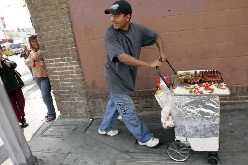 Two L.A. City Council members are calling for a study of how the city can legalize street vending. Above, a file photo of a hot-dog vendor in downtown L.A.