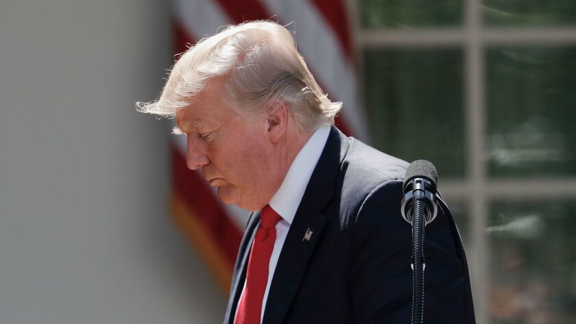 President Donald Trump walks away from the podium after speaking about the U.S. role in the Paris climate change accord on June 1 in the Rose Garden of the White House.