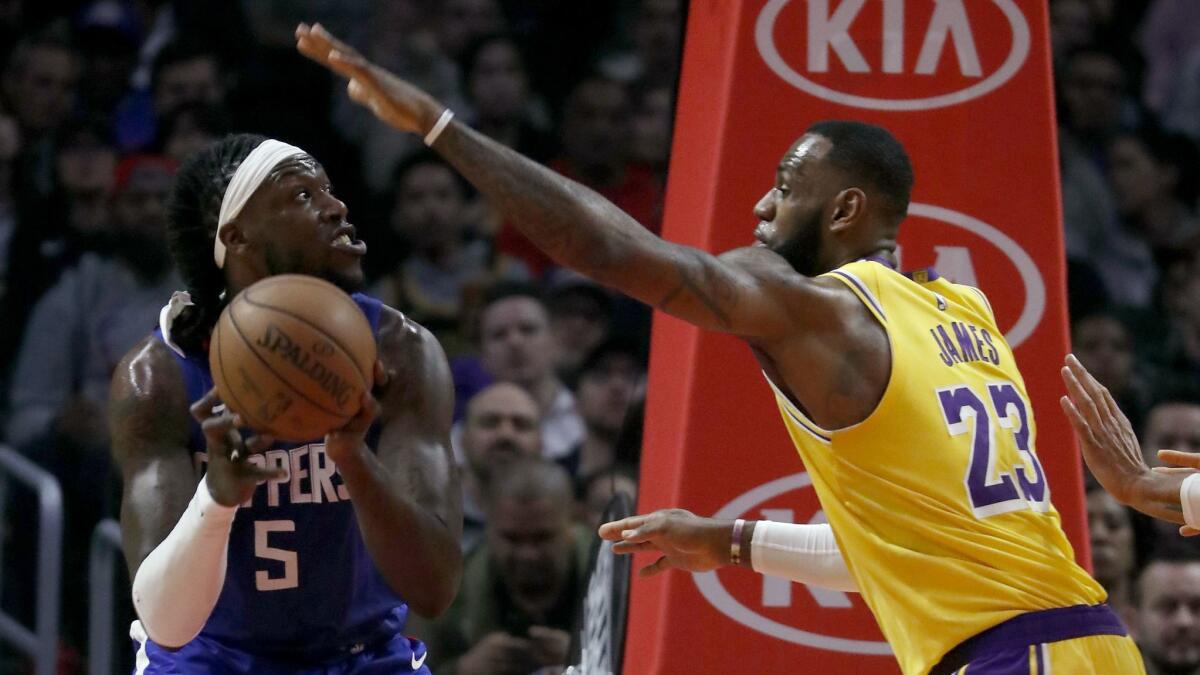 Lakers' LeBron James defends against Clippers' Montrezl Harrell in the second quarter.