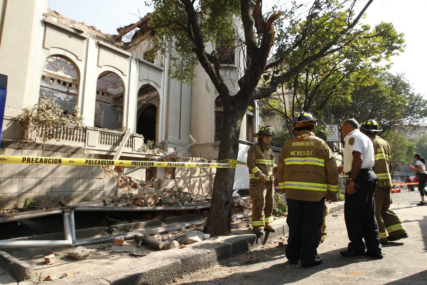 Firemen inspect a collapsed wall that is part of an old house after a 7.2 magnitude earthquake in Colonia Juarez neighborhood of Mexico City.