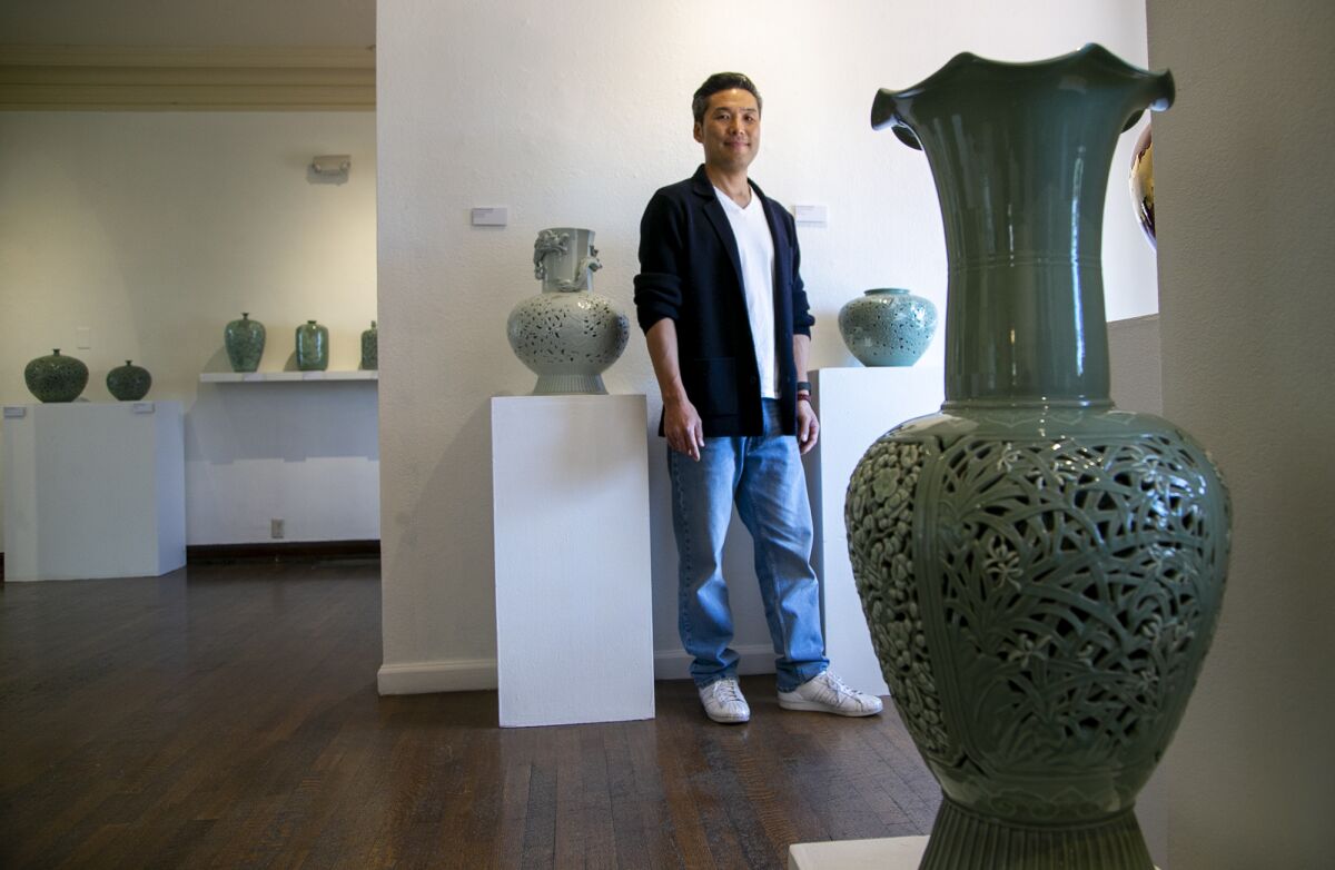 Dohun Kim with his exhibit "Story of a Thousand Years" at the Muckenthaler Cultural Center on May 2 in Fullerton.