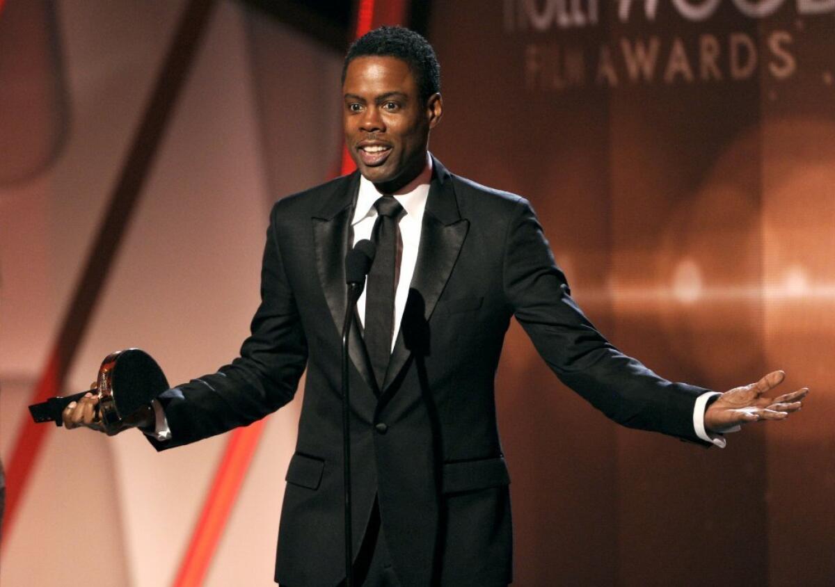 Chris Rock holds the award he has dreamed of receiving his entire life.