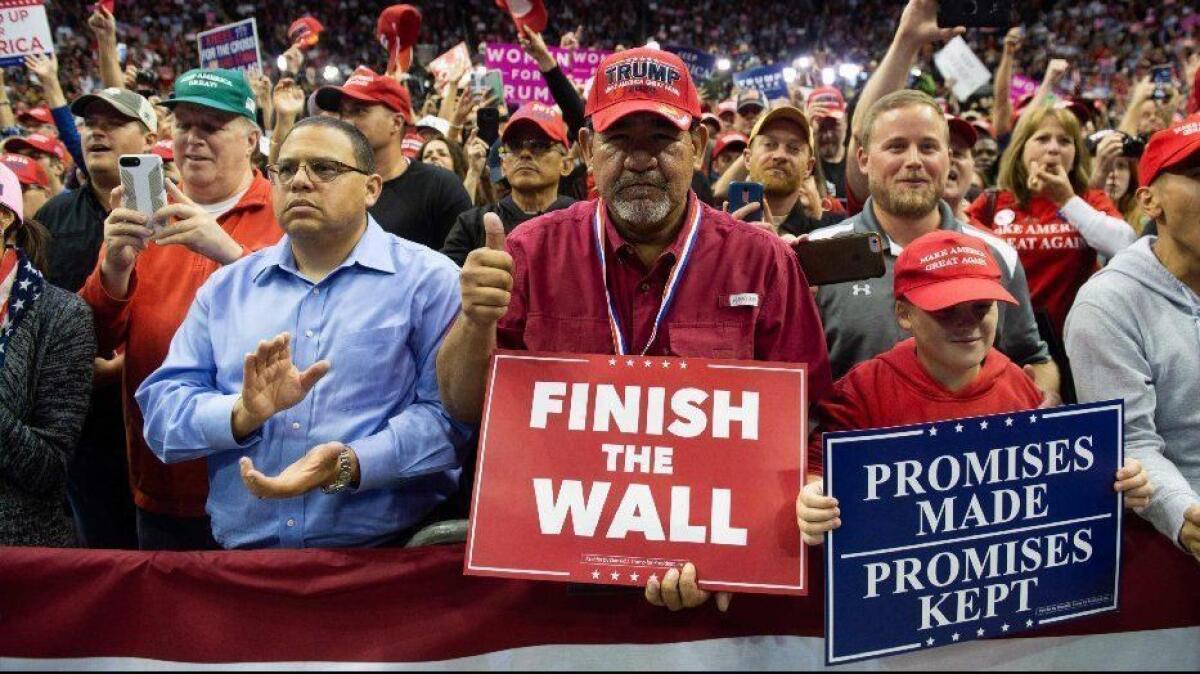 Supporters cheer President Trump during a campaign rally in Houston on Monday.