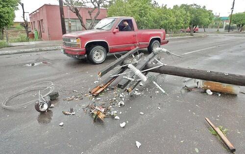 A man drives past by a fallen lamp post