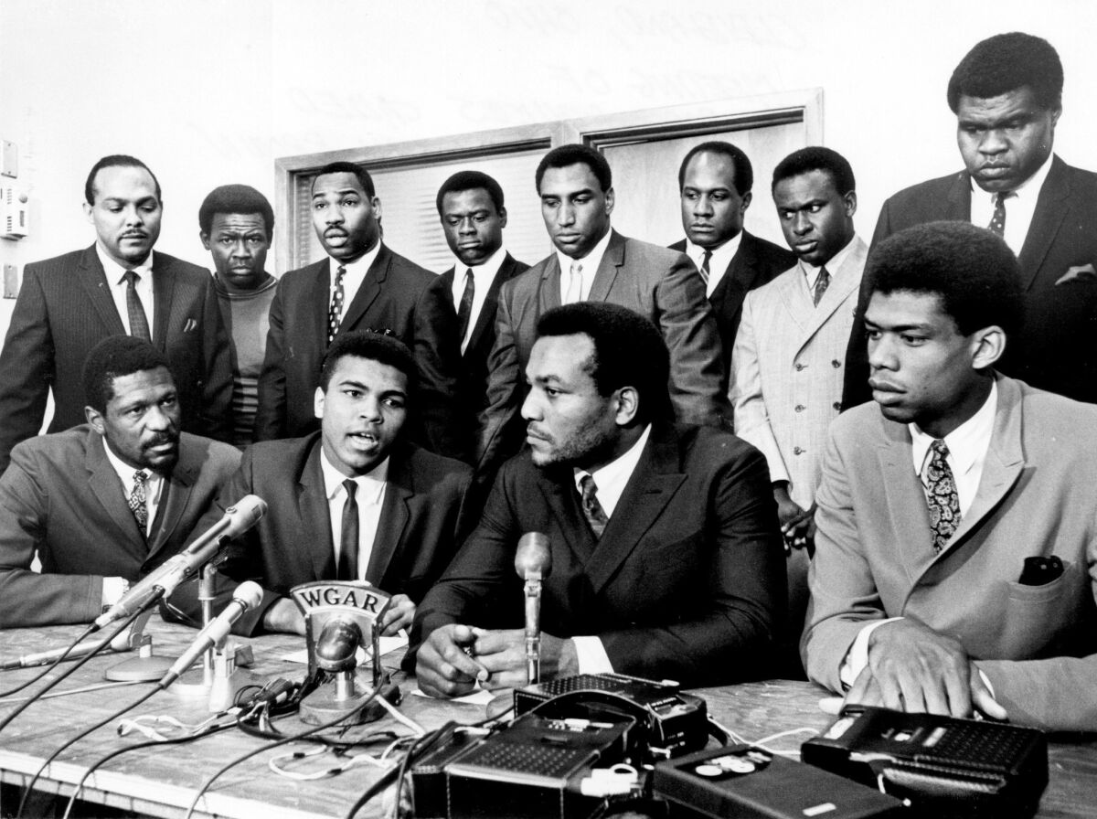 Kareem Abdul-Jabbar, front right, joins (right to left seated) Jim Brown, Muhammad Ali and Bill Russell on June 4, 1967. 