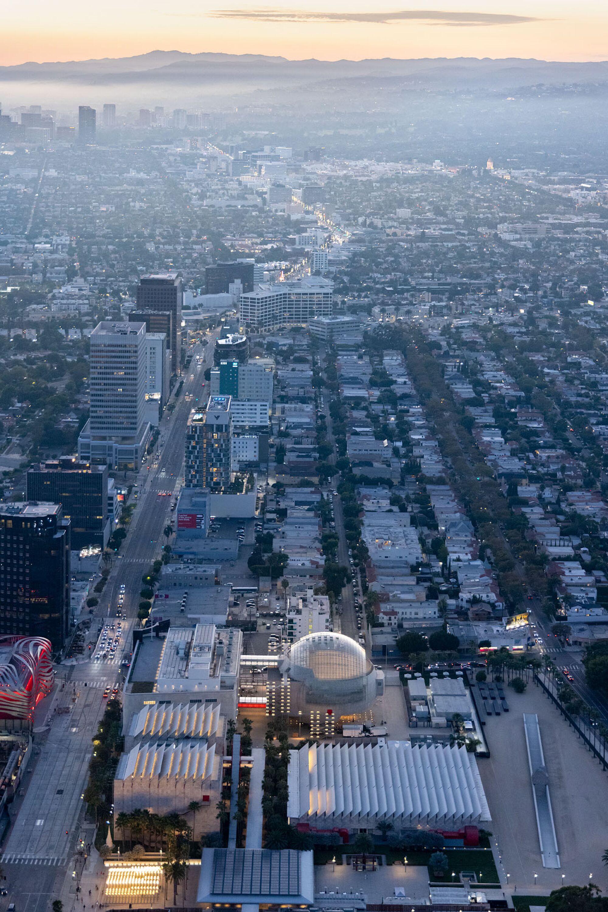 An aerial view of Los Angeles with mountains in the background