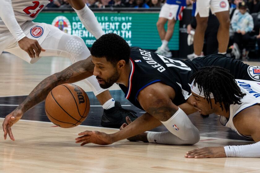 Los Angeles, CA - February 10: Clippers Paul George, no. 13, left, dives for a loose ball.