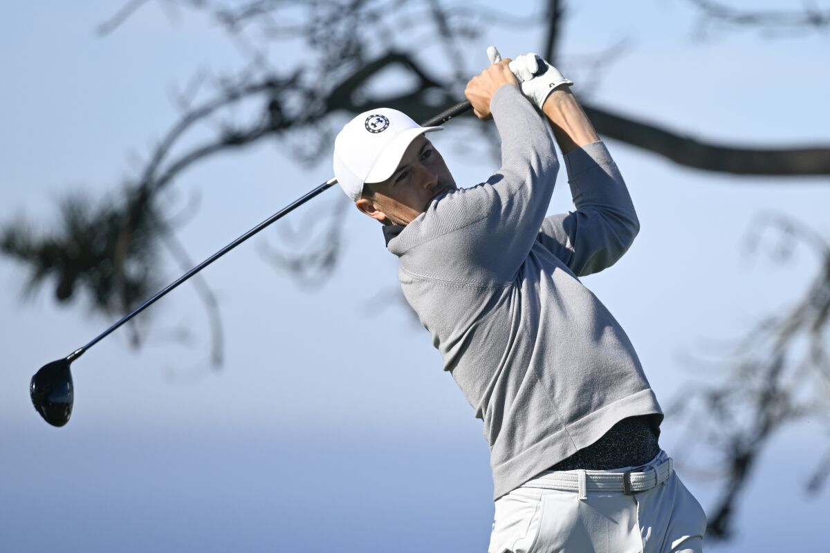 Jordan Spieth hits his tee shot on the 11th hole of the North Course at Torrey Pines during the first round of the Farmers Insurance Open golf tournament, Wednesday, Jan. 26, 2022, in San Diego. (AP Photo/Denis Poroy)