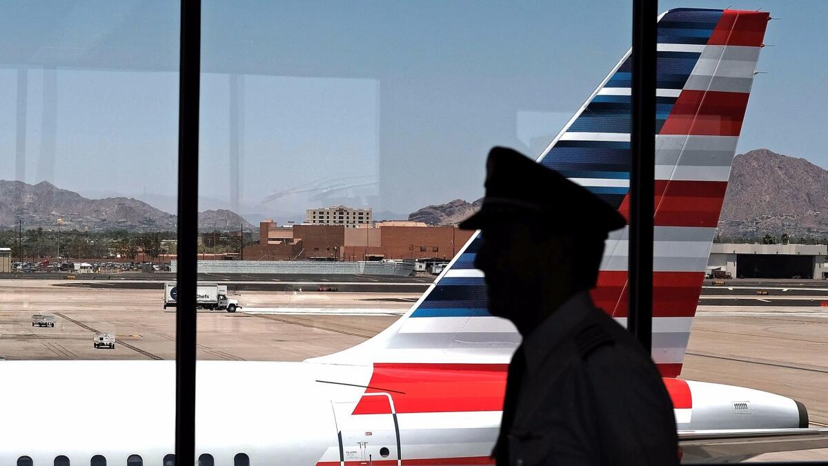 A pilot walks through the Phoenix airport.
