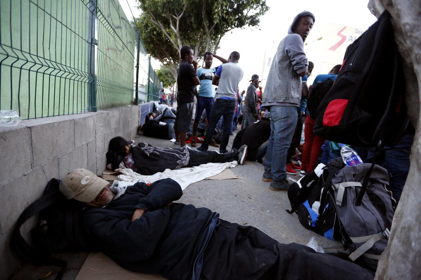Migrants sleep in the street acrossfrom the Desayunador Salesiano Padre Chava shelter in Tijuana, Mexico.
