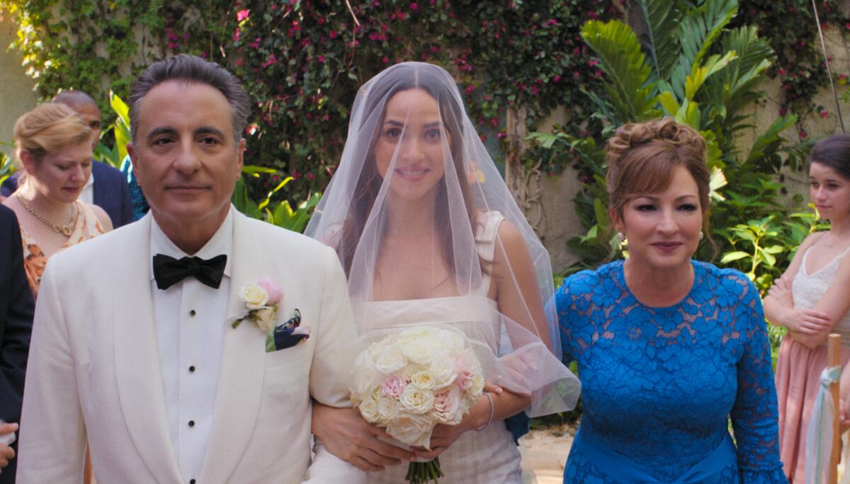 A man and woman flank the bride at a wedding in the movie "Father of the Bride."