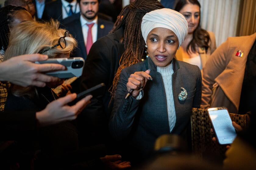 WASHINGTON, DC - FEBRUARY 02: Rep. Ilhan Omar (D-MN) departs from the House Chamber following a vote to oust her from the House Committee on Foreign Affairs on U.S. Capitol on Thursday, Feb. 2, 2023 in Washington, DC. The chamber approved the resolution in a party-line 218-211-1 vote. Rep. David Joyce (R-OH) voted present. (Kent Nishimura / Los Angeles Times)