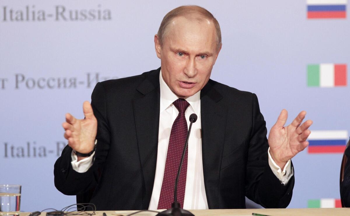 Russian President Vladimir Putin speaks at a news conference in Italy on Tuesday.