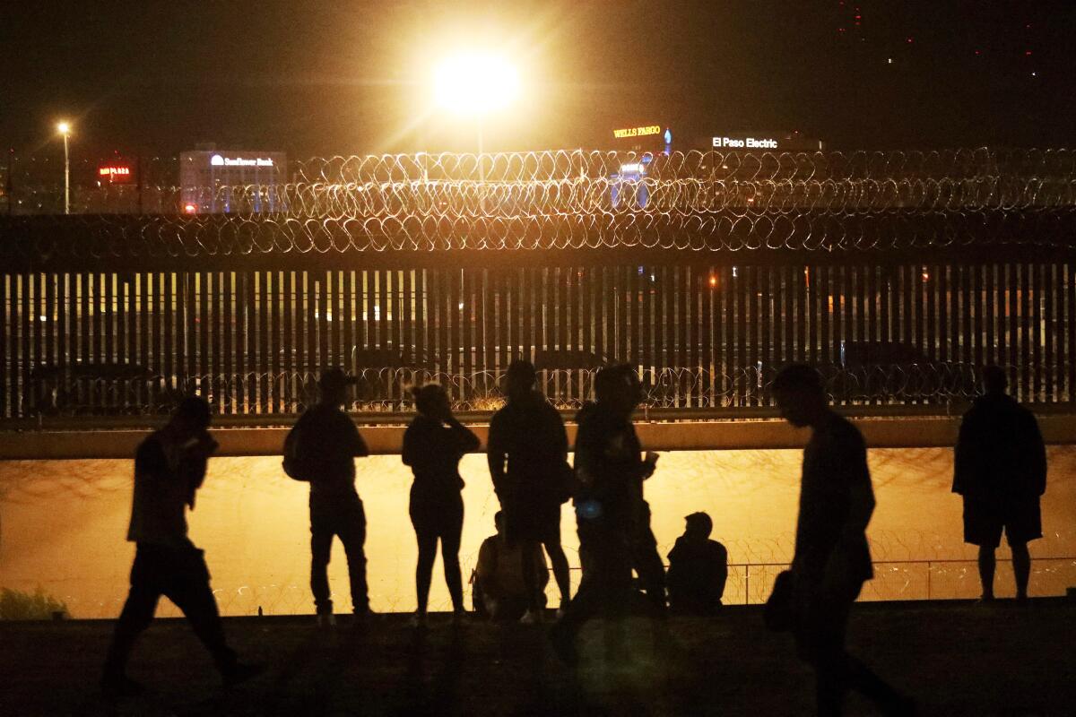 Migrants gather at the border between El Paso, Texas, and Ciudad Juarez, Mexico, on Aug. 7.