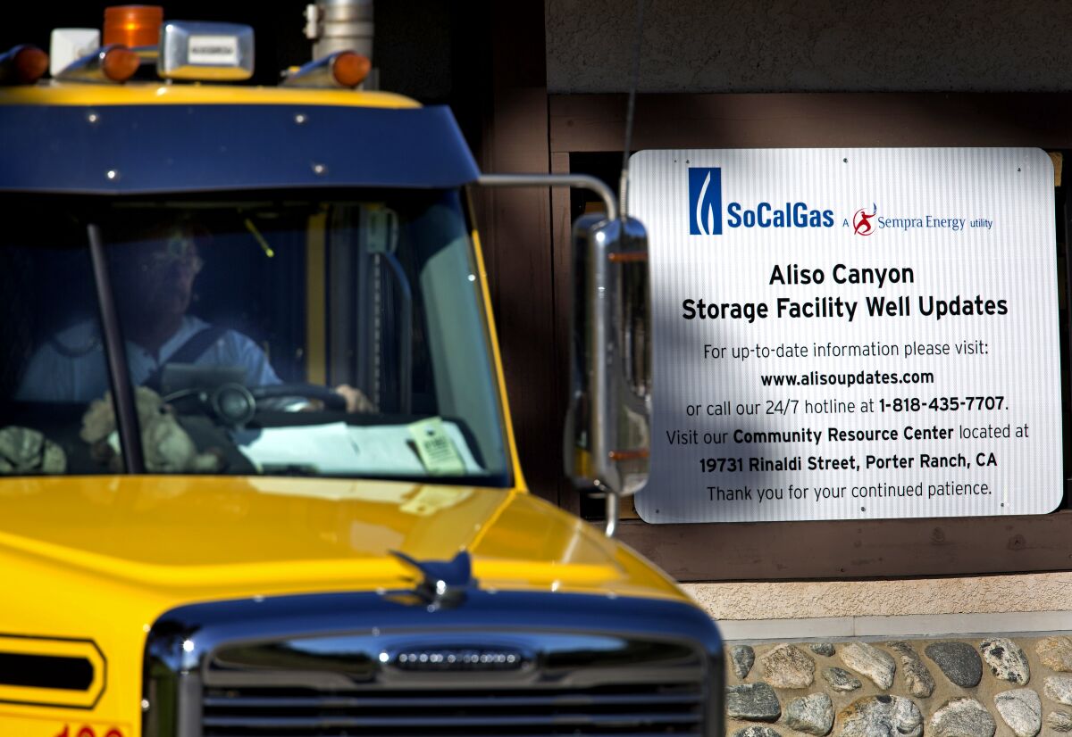 A truck drives past a sign for SoCalGas Aliso Canyon storage facility