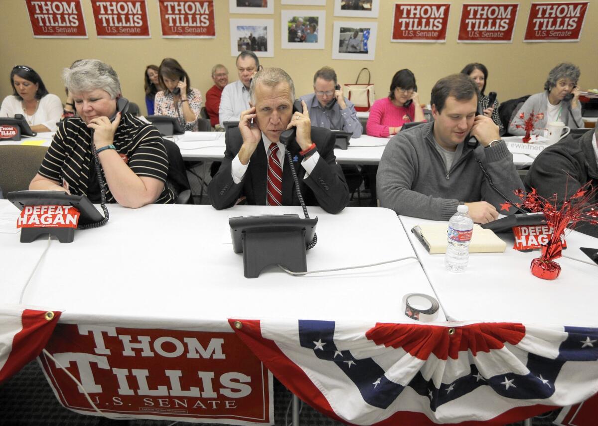North Carolina Republican Senate candidate Thom Tillis, center, makes calls to voters at his campaign office in Cornelius.