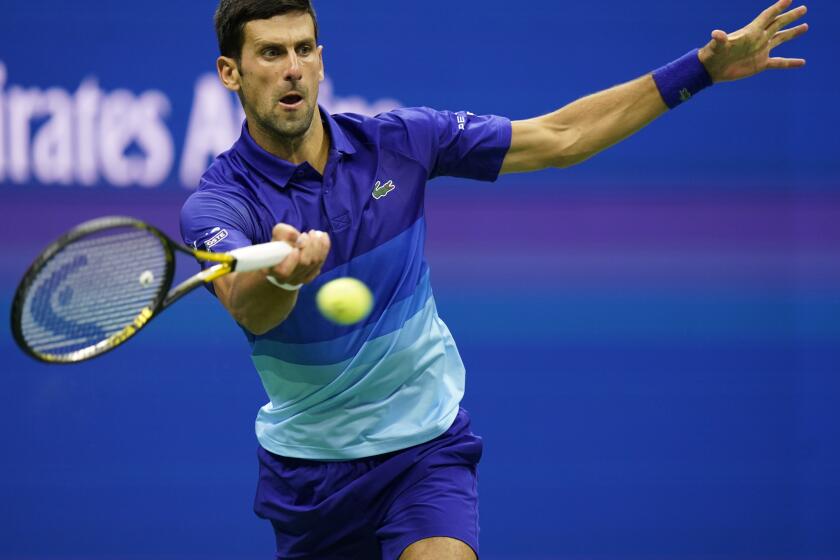 Novak Djokovic, of Serbia, returns a shot to Tallon Griekspoor, of the Netherlands.