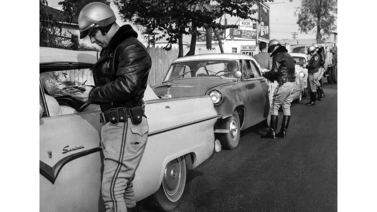 Dec. 23, 1958: C.A. Smith and other California Highway Patrol officers question motorists in East Los Angeles at a holiday traffic stop.