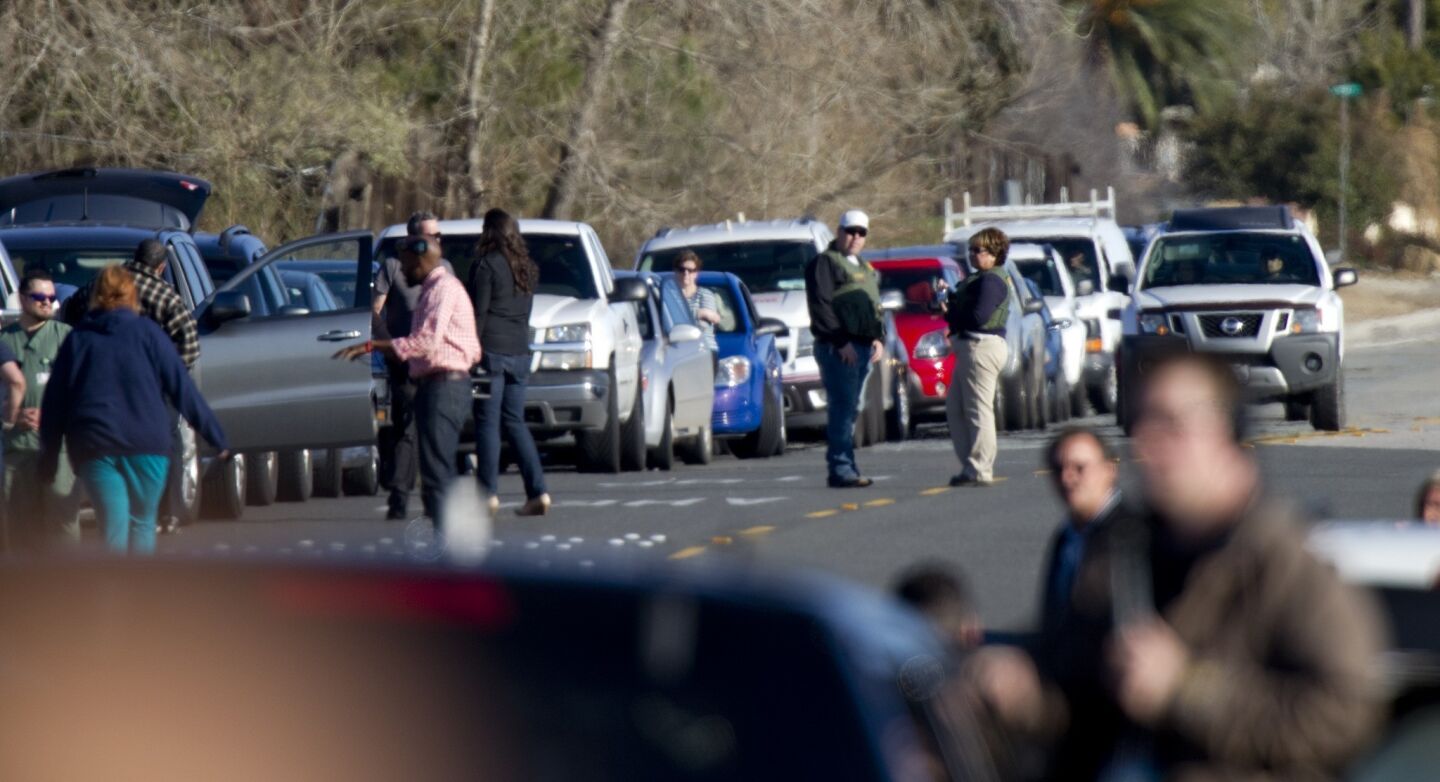 Vehicles line up along Bryant Road near a roadblock at Highway 38 north of Redlands.