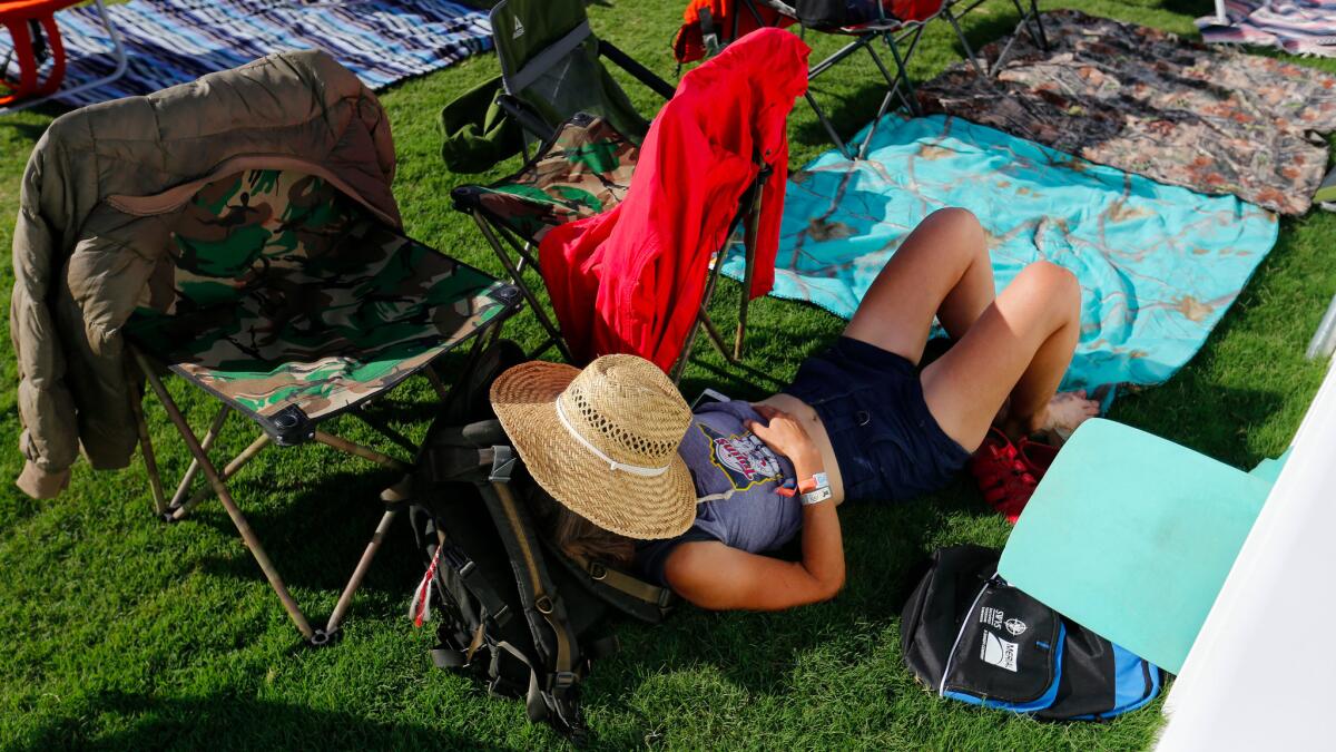 A concertgoer takes a rest on the grounds of the Desert Trip festival in Indio.