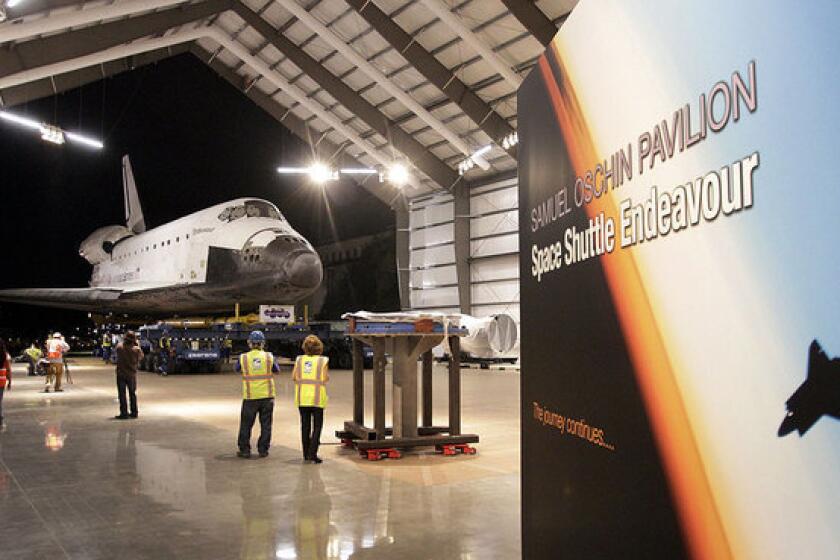 The decommissioned space shuttle Endeavour reaches its final home in Los Angeles in October. A committee of the National Research Council discussed the direction of NASA's human space flight program in Washington on Wednesday.