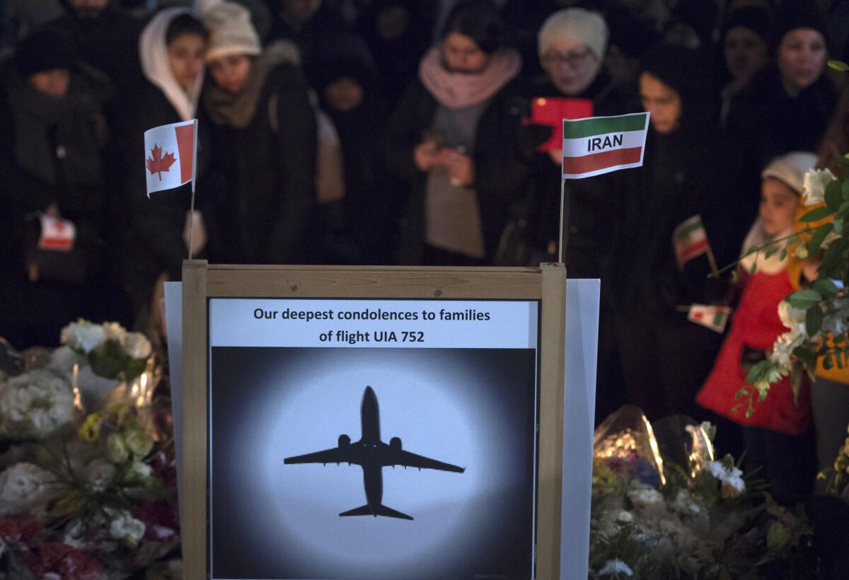 A sign that reads "Our deepest condolences to families of flight UIA 752" at a memorial.