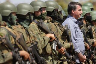 Brazilian President Jair Bolsonaro poses for photos with the soldiers during annual military exercises by the Navy, Army and Air Force, in Formosa, Brazil, Monday, Aug. 16, 2021. (AP Photo/Eraldo Peres)