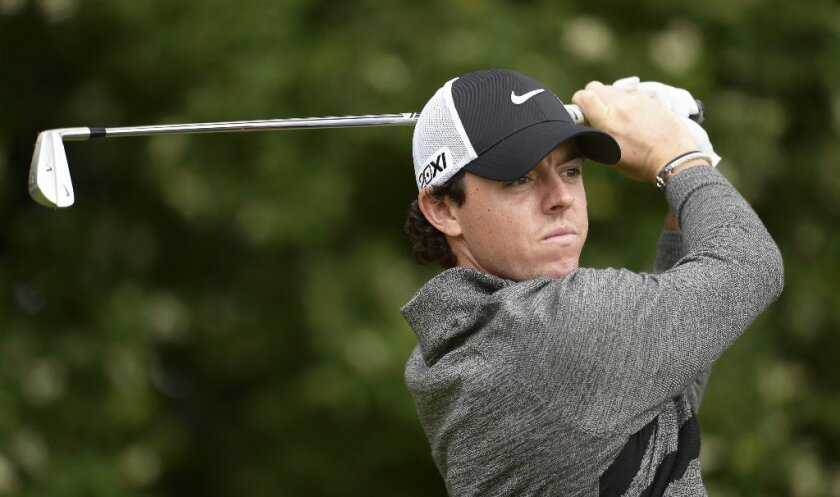 Golfer Rory McIlroy takes a swing.